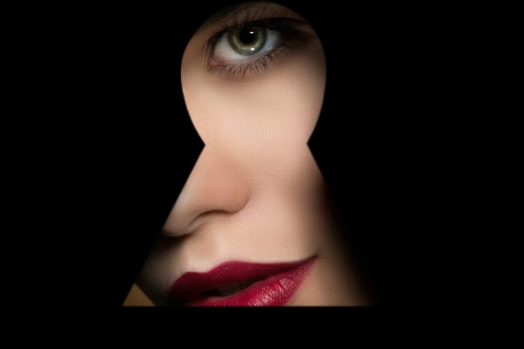 Pretty eyeball looking through peephole