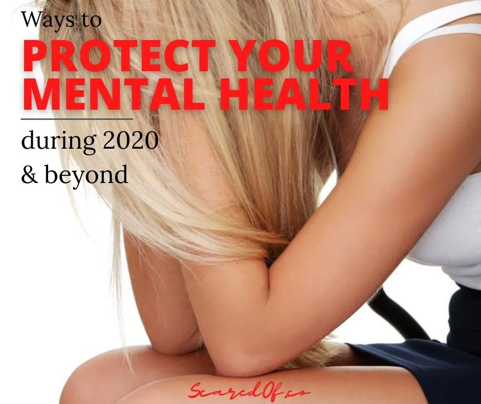 Blonde girl with her head in her hands on her knees.